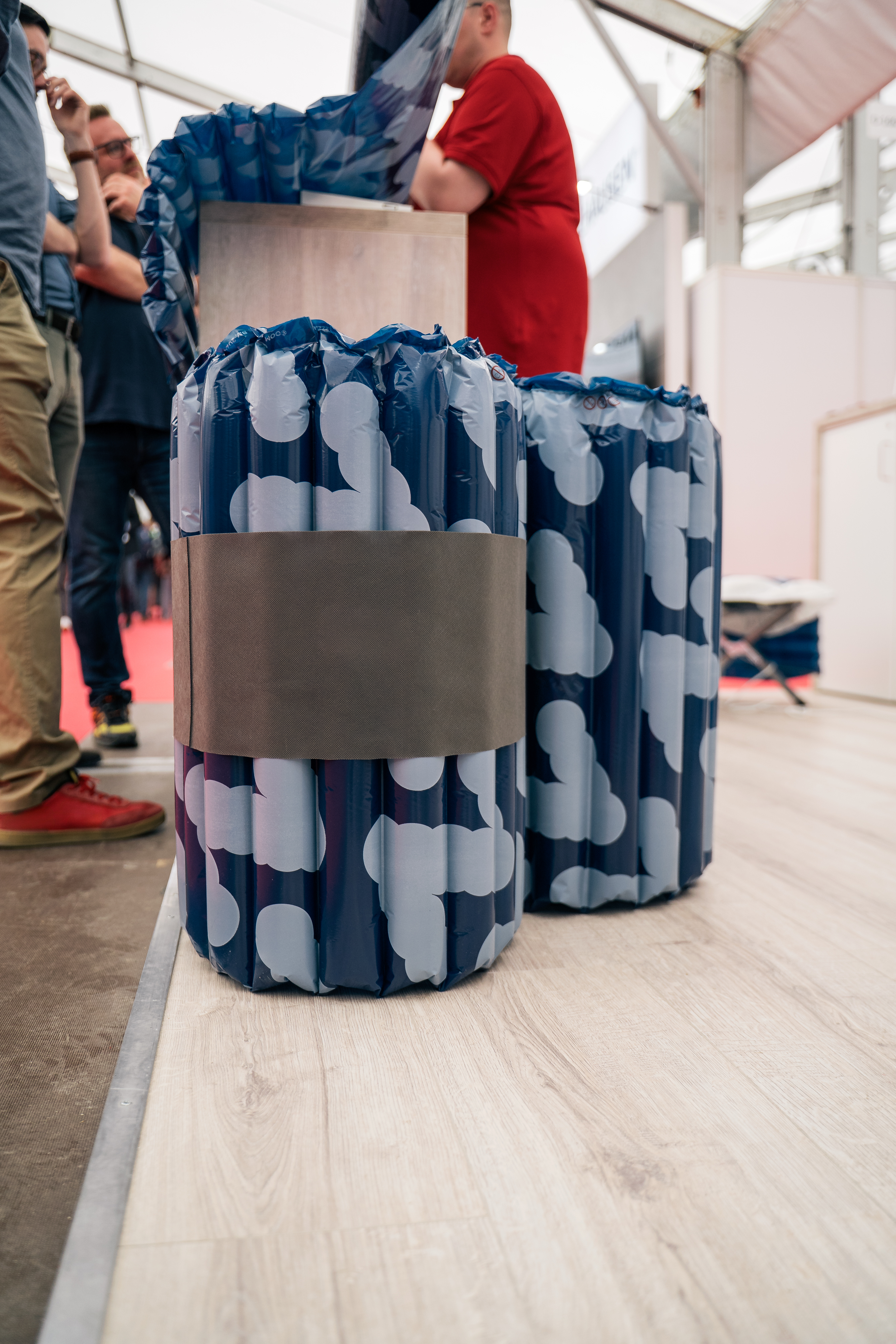 Rolled up air mattress in a trade fair booth